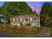 Charming single-story home with a well-maintained yard and cozy front porch and attractive landscaping at 1068 14Th Nw Ave, Hickory, NC 28601
