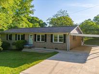 Charming brick home with well-maintained lawn, a covered carport, and a welcoming front entrance at 1277 Rainbow Cir, Catawba, SC 29704