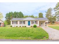 Charming single-story home with a bright blue front door and well-maintained lawn at 212 Pine St, Rockwell, NC 28138