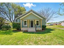 Charming green bungalow with a welcoming front porch and well-manicured lawn at 224 Adrian St, Mount Holly, NC 28120