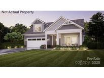 Charming two-story home featuring a manicured lawn, a two car garage and a welcoming front porch with chairs at 3 Five Creek Rd # 3, Charlotte, NC 28213