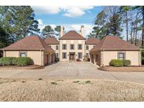 Grand estate featuring a symmetrical design, dual garages, and manicured grounds at 3005 Dream Catcher Cir, Fort Mill, SC 29715