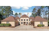 Stately home featuring a long driveway, multiple garages, and manicured landscaping at 3005 Dream Catcher Cir, Fort Mill, SC 29715