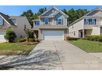 Charming two-story home featuring a two-car garage, inviting curb appeal, and well-maintained landscaping at 78090 Rillstone Dr, Lancaster, SC 29720