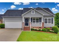 Charming single Gathering home with a manicured lawn, gray siding and attached garage at 835 Holdcroft Ln, Rock Hill, SC 29730