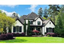 Charming two-story home with a landscaped yard and a classic white facade with black trim at 887 Harvest Pointe Dr, Fort Mill, SC 29708