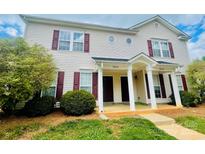 Inviting townhouse with a charming entrance and manicured landscaping at 9615 Littleleaf Dr, Charlotte, NC 28215