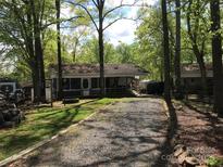 Charming single-story home with gravel driveway surrounded by mature trees at 108 Captains Ct # B116, Mount Gilead, NC 27306