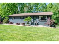 Charming single-story home with a well-manicured lawn, mature trees, and inviting curb appeal at 119 Meadowbrook Ln, Davidson, NC 28036