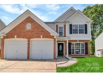 Charming two-story home features a brick facade, two-car garage, and manicured front lawn at 1216 Stourbridge Lion Dr, Charlotte, NC 28213