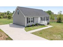 Charming single-story home with gray siding, black shutters, and a well-manicured front yard at 123 Pumice Dr, Statesville, NC 28625