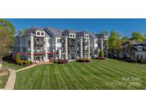 Multi-story condo features a large lawn with mature landscaping and private balconies in a desirable community setting at 18700 Nautical Dr # 101, Cornelius, NC 28031