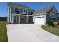 Charming two-story home featuring stone accents, a covered porch, and a spacious two-car garage at 2069 Fordhill St, Rock Hill, SC 29732