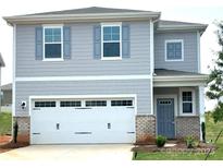 Charming two-story home with gray siding, gray shutters, a brick base, and a two-car garage at 290 Bezelle Ave, York, SC 29745