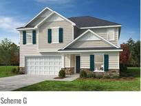 Charming two-story home with a two-car garage, stone accents, and teal shutters against light beige siding at 4561 Family Trail Dr, Indian Land, SC 29707