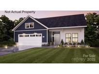 Charming craftsman style home with a two-car garage, lush lawn, and beautifully landscaped front yard at 4831 Reason Ct # 72, Harrisburg, NC 28075