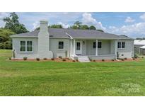 Charming single-story home with a brick exterior, a front porch, and a well-manicured lawn at 4979 Plateau Rd, Vale, NC 28168