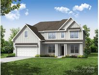 Charming two-story home featuring a covered front porch and a well-manicured lawn with beautiful landscaping at 5380 Pembrey Dr # Lot 26, Denver, NC 28037