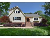 Charming two-story home with landscaped front yard and traditional architectural details at 6008 Corkstone Dr, Mint Hill, NC 28227