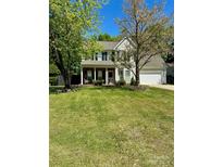 Traditional two-story home with inviting porch and a well-maintained lawn at 9003 Brad Ct, Matthews, NC 28104