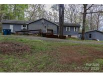 View of home featuring accessible ramp to entrance, lawn, and mature trees at 9216 Caycee Dr # 32, Davidson, NC 28036