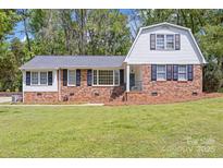 Charming brick home with a gambrel roof, well-manicured lawn, and inviting curb appeal at 101 Grier St, York, SC 29745