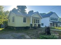 Charming single-Gathering home featuring a covered front porch and quaint architectural details at 116 Morning Glory Ave, Belmont, NC 28012