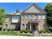 Charming brick townhome with well-maintained landscaping and a welcoming entrance on a sunny day at 12421 Fiorentina St, Charlotte, NC 28277