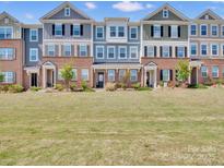 Charming townhomes featuring colorful exteriors, brick accents, and well-maintained landscaping offer curb appeal at 138 Marron Dr # 25, Indian Trail, NC 28079