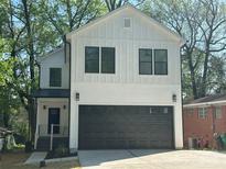 Charming two-story home with modern black garage door, neutral color, and eye catching design at 1413 Hateras Ave, Charlotte, NC 28216