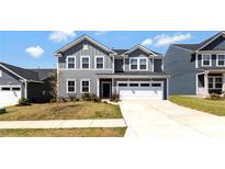 Charming two-story home with a well-maintained lawn and a two-car garage at 14224 Canemeadow Dr, Charlotte, NC 28278