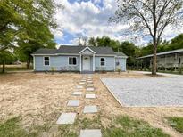 Charming single-story home with light blue siding and a walkway of stepping stones to the front door at 171 Three Cs Rd, Kershaw, SC 29067