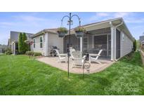 Cozy outdoor patio with comfortable seating, a grill, and string lights for relaxing evenings at 4831 Looking Glass Trl, Denver, NC 28037
