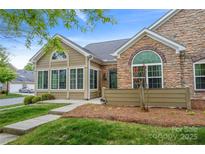 Inviting home with siding and stone details, featuring a neatly arranged landscape and clear pathway at 6311 Ridge Path Ln, Charlotte, NC 28269