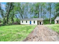Quaint single-story home featuring fresh exterior paint, a bright blue door, and spacious front yard at 805 32Nd Street Ne Dr, Conover, NC 28613