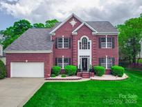 Beautiful brick two-story home with a well-manicured lawn and inviting front entrance at 9001 Fenwick Dr, Indian Trail, NC 28079