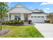 Charming home with a well-maintained lawn and a welcoming front porch at 9077 Myrna Dr, Gastonia, NC 28056