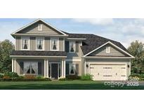 Charming two-story home featuring a welcoming front porch, attached two-car garage, and manicured lawn at 1015 Gardenia Dr # 52, Mt Ulla, NC 28125