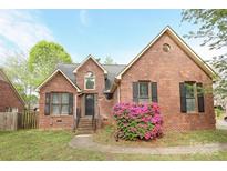 Charming brick home with black shutters and a beautifully landscaped front yard, ready for new owners at 1121 Thoroughbred Nw Pl, Concord, NC 28027