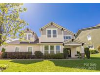 Charming home with a well-manicured lawn and inviting front porch at 12942 Blakemore Ave, Huntersville, NC 28078