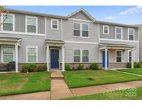 Gray siding townhome with well-maintained lawn and landscaping at 221 Century Dr, Salisbury, NC 28147