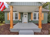 Charming front porch with wooden posts, shutters, and a 'Welcome' sign for a cozy entrance at 2222 Moose Rd, Kannapolis, NC 28083