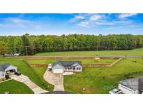 Expansive fenced yard surrounds this home with an attached garage and covered front porch at 3659 Kimber Ln, Sherrills Ford, NC 28673