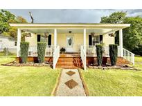 Charming home featuring a cozy front porch with rocking chairs and beautiful landscaping at 45 Oak St, Great Falls, SC 29055