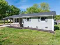 Charming one-story home with fresh, neutral paint, inviting curb appeal and a neatly maintained lawn at 692 S Pink St, Cherryville, NC 28021