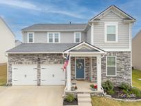 Charming two-story home with stone accents, a two-car garage, and a welcoming front porch at 228 Brownstone Dr, Rock Hill, SC 29730
