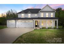 Stunning two-story home with three-car garage, manicured lawn, and inviting front porch at 8756 Sherrills Ford Rd, Sherrills Ford, NC 28673