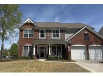 Charming two-story brick home with a well-manicured lawn and a two-car garage at 10354 Scotland Ave, Fort Mill, SC 29707