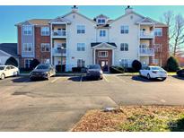 Well-maintained condo building featuring balconies and ample parking at 10526 Hill Point Ct, Charlotte, NC 28262
