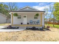 Charming single-story home with a welcoming front porch, complemented by tidy landscaping and a well-manicured lawn at 109 W Poplar St, Stanley, NC 28164
